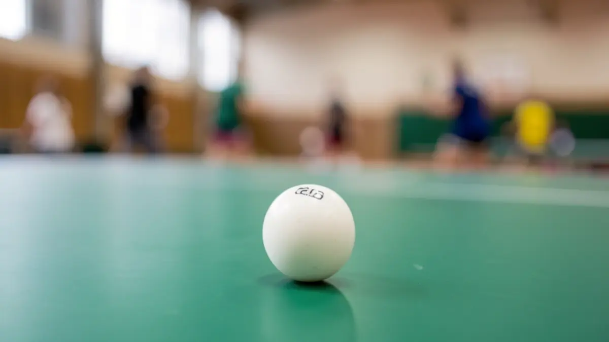 Generic image of a table tennis ball on a green table.